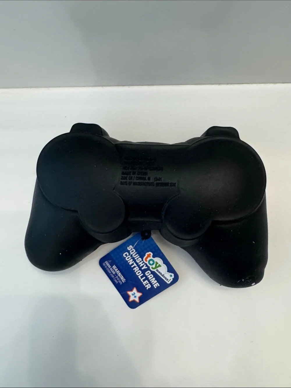 Black Squishy Game Controller Stress Toy with Green and Blue Buttons